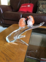 Two orange and sterling silver birds on a branch