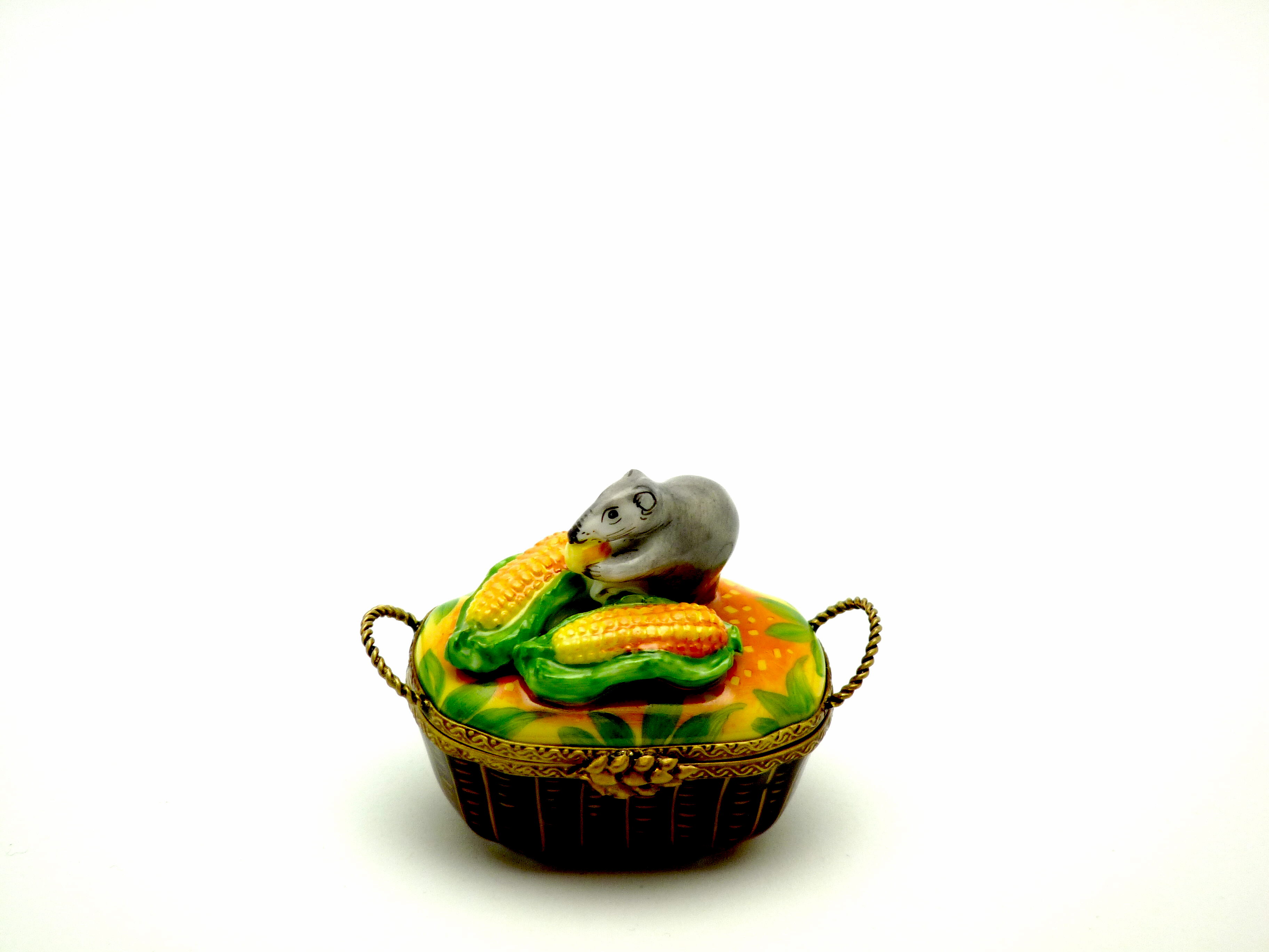 Mouse sitting on corns in basket