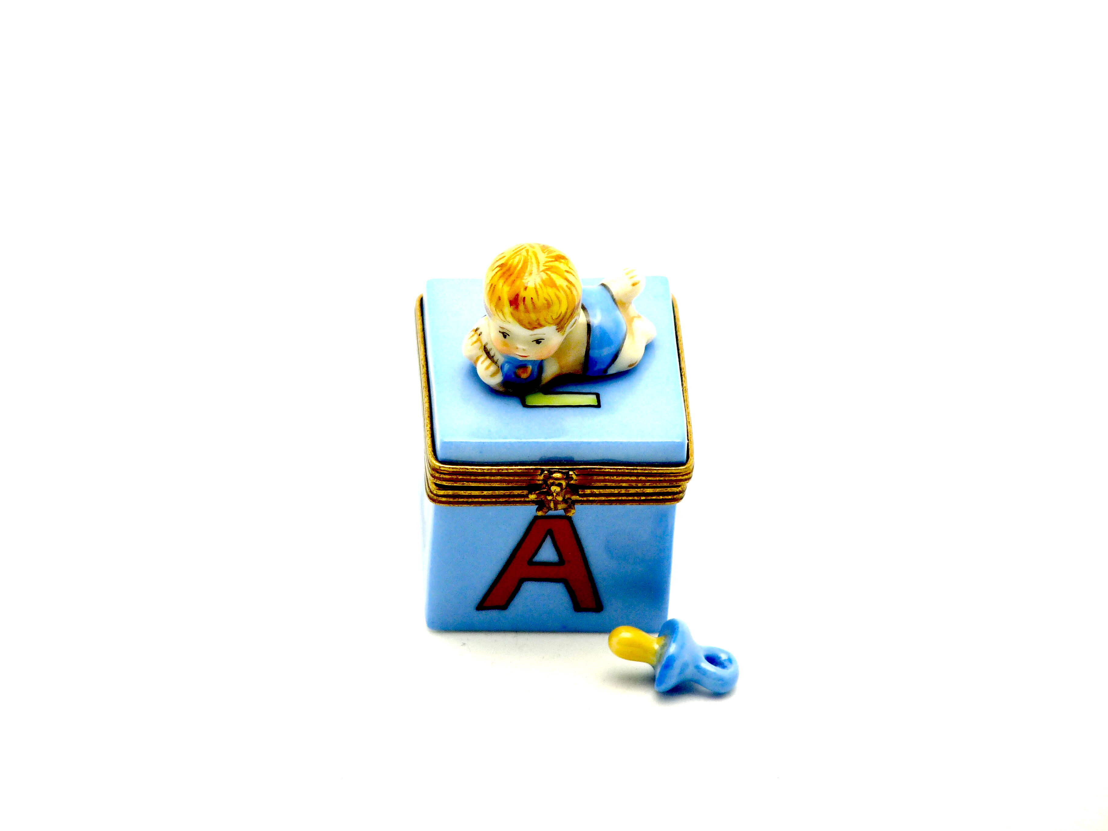 Baby boy on ABC block with pacifier