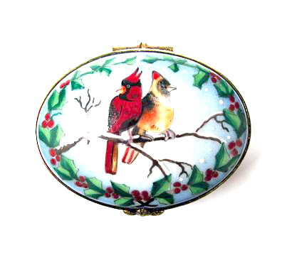Cardinals on oval red with holly leaves