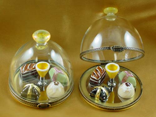 Domed dessert tray with pastries and champagne