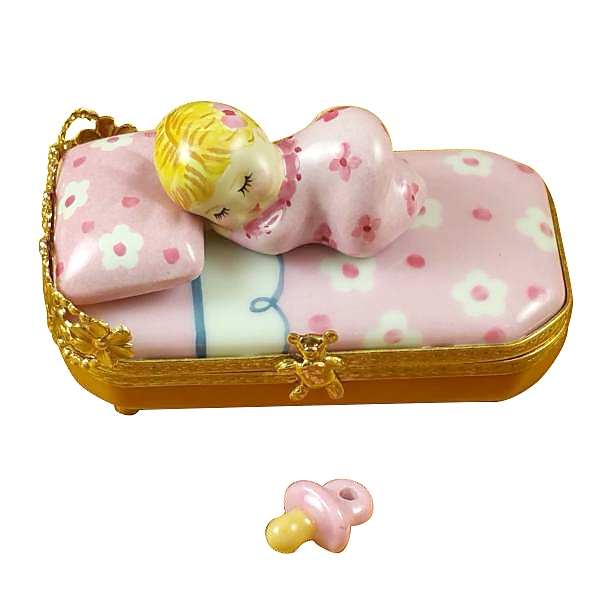 BABY IN PINK BED WITH PACIFIER