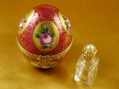 Burgundy and gold egg with perfume bottle