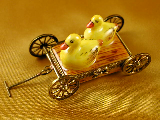 Two ducks on pull cart