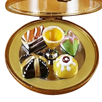 Domed dessert tray with pastries and champagne